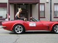 Miss July 4 in red corvette in front of Attica Hotel