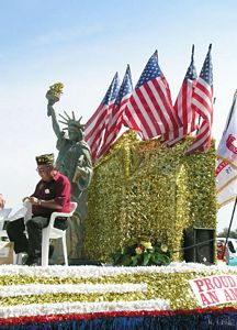 Veteran's Float with Waving Flags in Breeze and Statue of Liberty